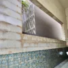 Exterior granite wall staining before cleaning at coastal landed property in Singapore